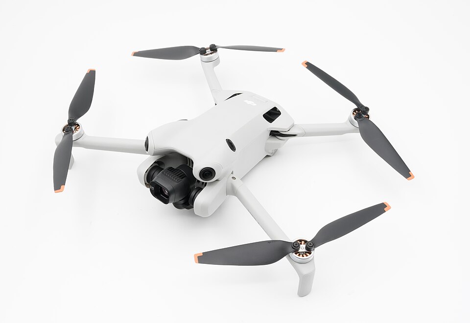 Foldable camera drone with four propellers on a white background